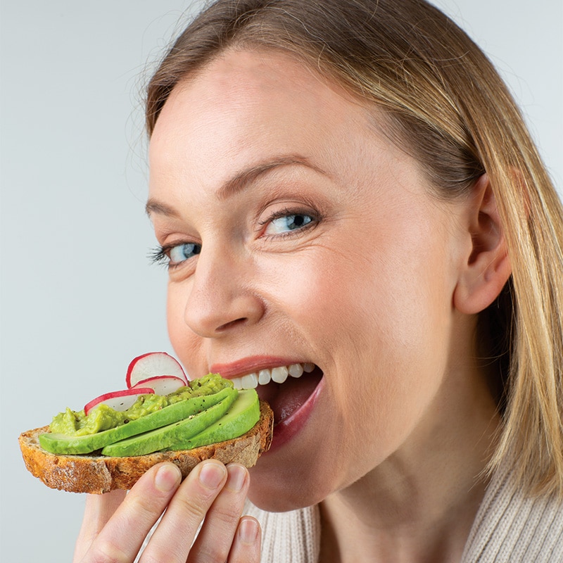 woman eating avocado toast