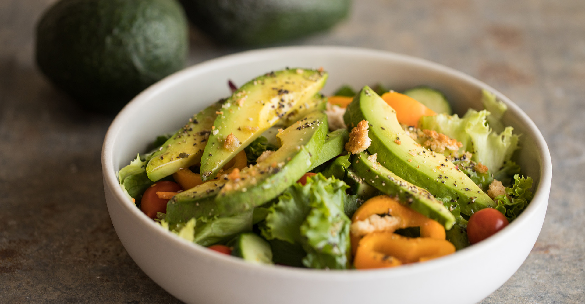 bowl filled with salad and topped with avocados